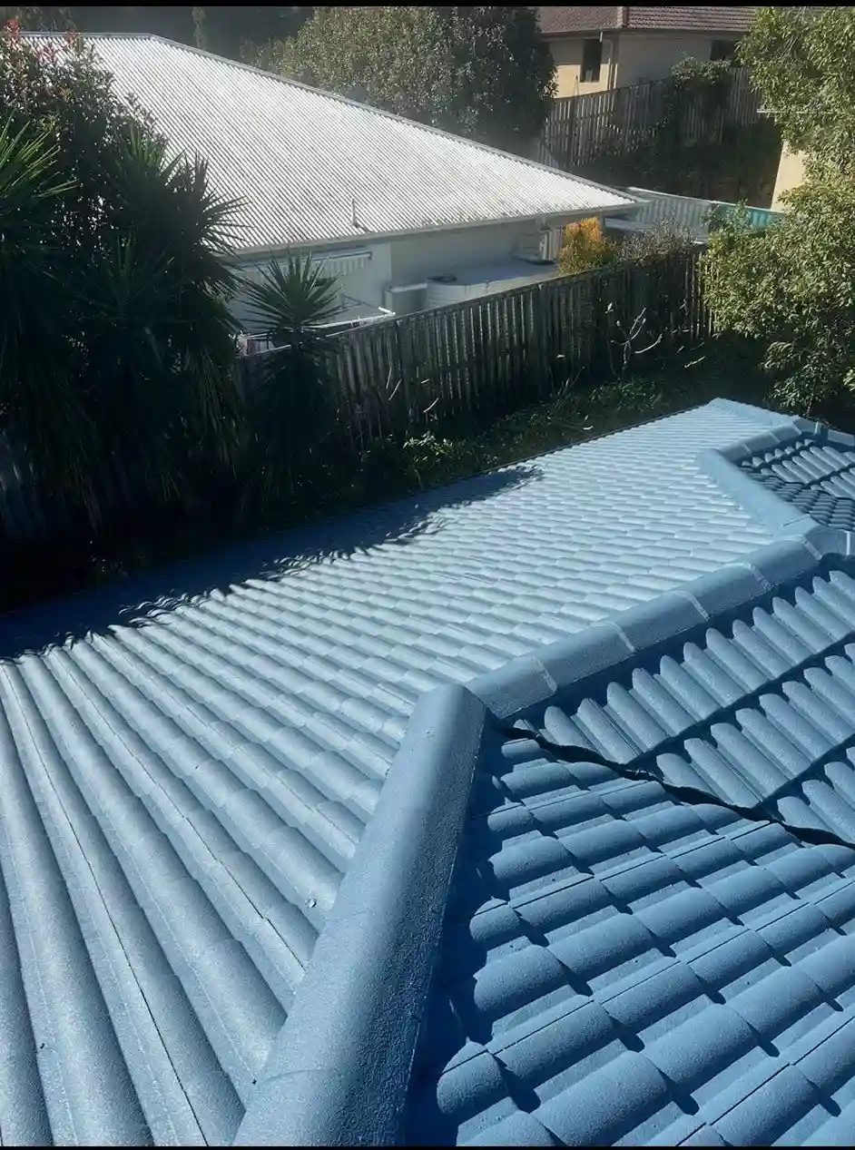 Bright blue painted metal roofing tiles on residential home